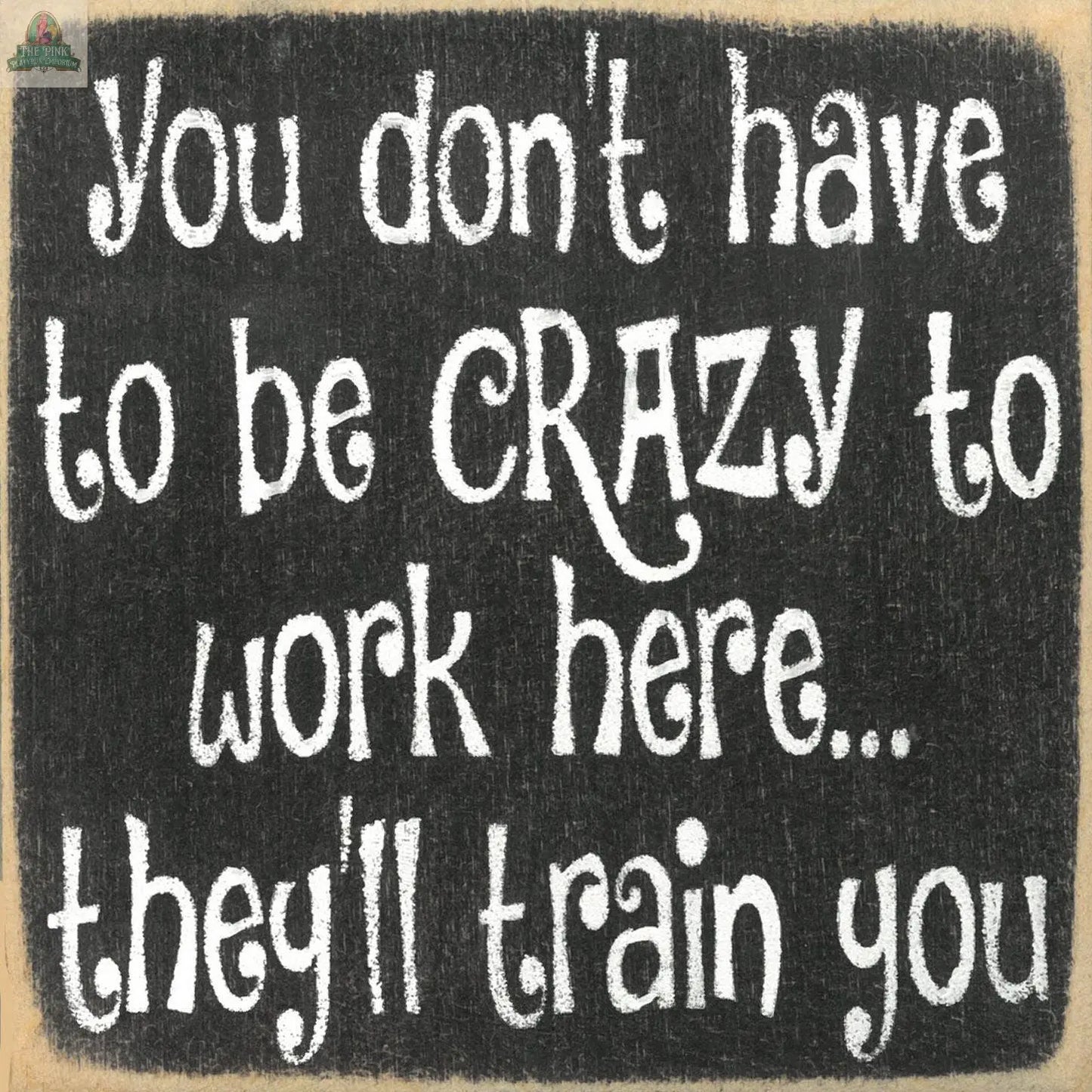 Add humor to your home with the Pink Platypus Emporium "You Don't Have to be Crazy to Work Here" wooden sign—a chalkboard-style decor piece featuring quirky white text that's sure to make guests smile.