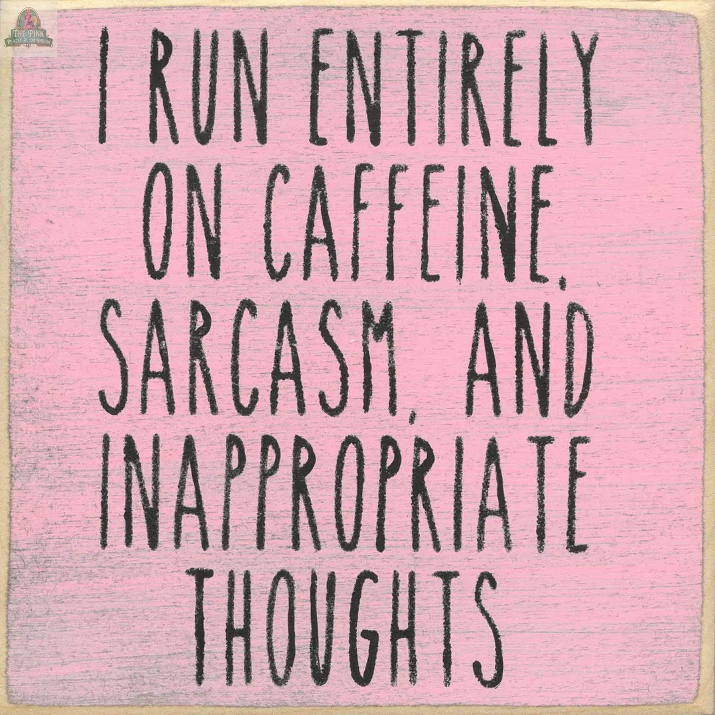 Text on a pink background reads: I run entirely on caffeine, sarcasm, and inappropriate thoughts in bold black letters. The 5X5- Inappropriate Thoughts wood sign by Pink Platypus Emporium adds playful charm to quirky home decor.