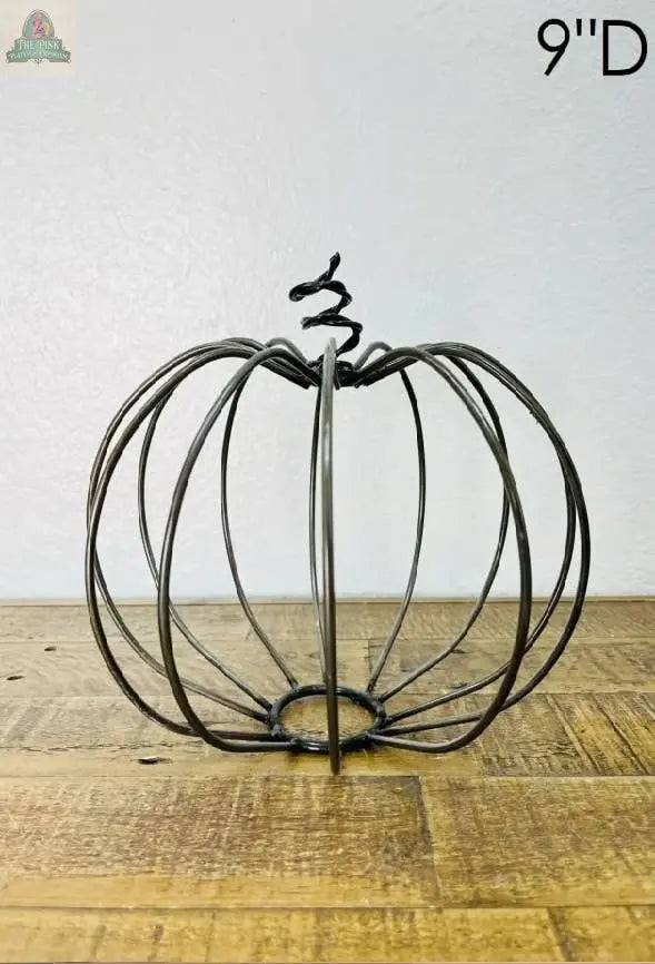 The Pink Platypus Emporium Metal Pumpkin Decor features a 9-inch metal wire pumpkin-shaped frame with a spiral stem, perfect for adding autumn charm to your fall decorations or Thanksgiving decor.