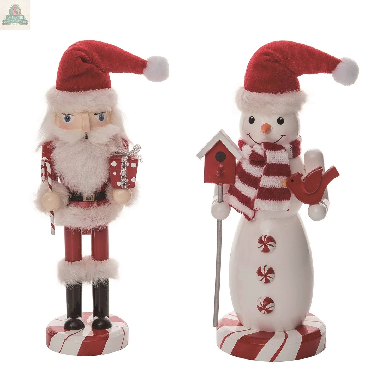 Transpac’s Christmas Wooden 10” Snowman/Santa Nutcracker Set includes a Santa nutcracker with a present and a snowman with a striped scarf, birdhouse, and red bird, both on red-and-white striped bases.