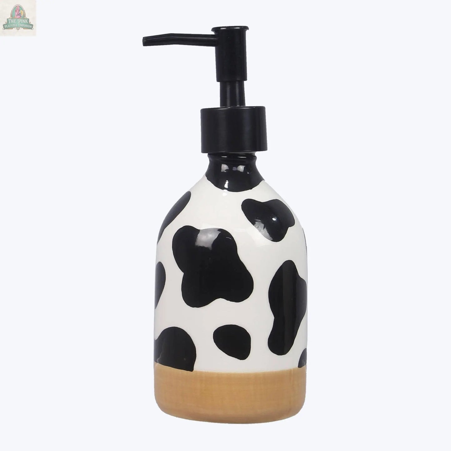 The Ceramic Cow Soap Dispenser has a white body with black cow spots, a light brown base, and a black pumpâideal for farmhouse style or as charming cow-themed bathroom decor.
