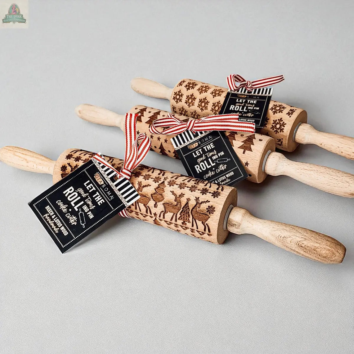 The Christmas Rolling Pin Set | 10 Styles features engraved wooden pins tied with striped ribbons and black gift tags—a charming baking gift perfect to pair with cookie cutters for the holidays.