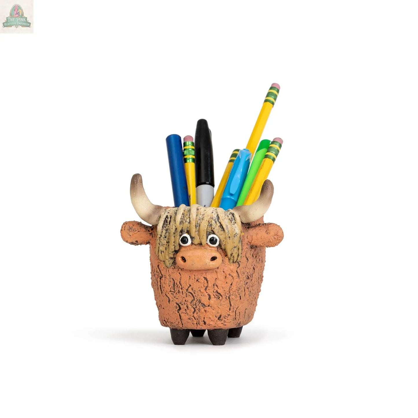 Dougal the Highland Cow Blob House Planter by Pink Platypus Emporium—a small brown ceramic cow-shaped pot with horns, shown holding yellow pencils and pens on a white background—makes a charming garden decor or cute desk accessory.