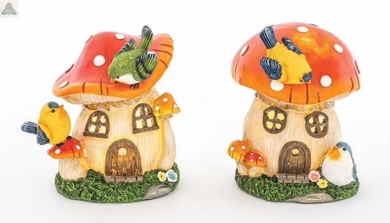 The Feathered Friends Mushroom House w LED 2 Ast features two mushroom houses with red caps, white spots, colorful birds, and floral details on a white background—each measures about 5.31" and 7.28" tall.