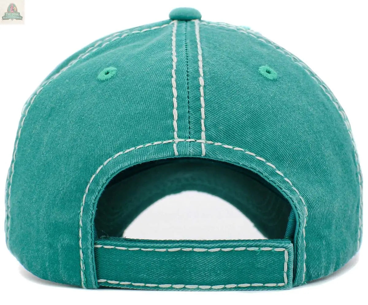 The Fluffy Floral Cow Vintage Ballcap by Pink Platypus Emporium is a teal cap shown from the back, with white stitching and an adjustable hook-and-loop strap—ideal for fans of classic or floral cow print hat styles.