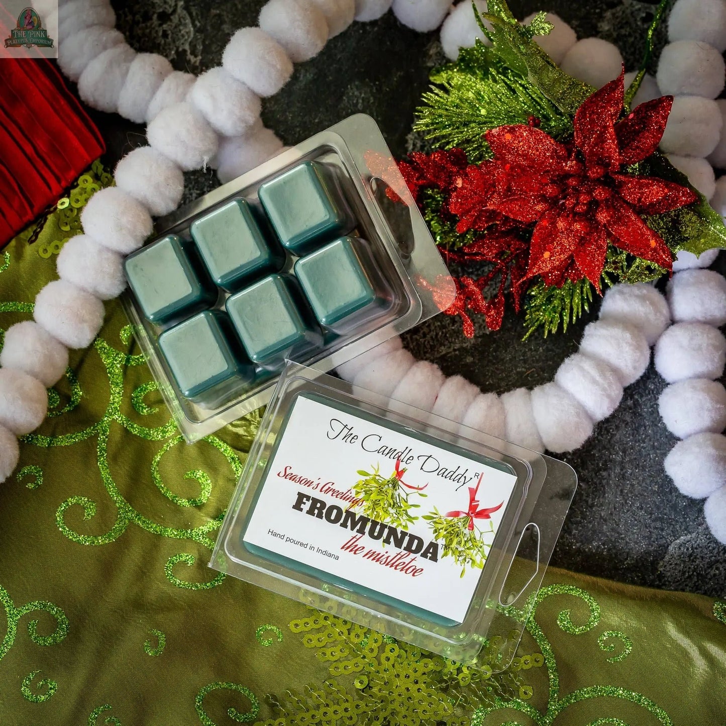 Fromunda The Mistletoe – Funny Christmas Under the Mistletoe wax melts (1 pack, blue, mistletoe scent) on green fabric with white garland and poinsettia—makes a hilarious and festive Christmas wax melt gift.
