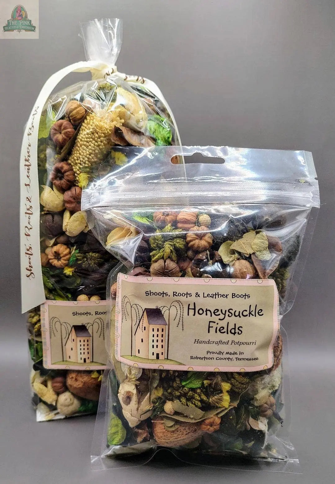 Two clear bags of Honeysuckle Fields Handcrafted Potpourri (5 cups each) by Pink Platypus Emporium, filled with dried flowers, leaves, and nuts for a natural eco-friendly fragrance, are displayed against a plain gray background.