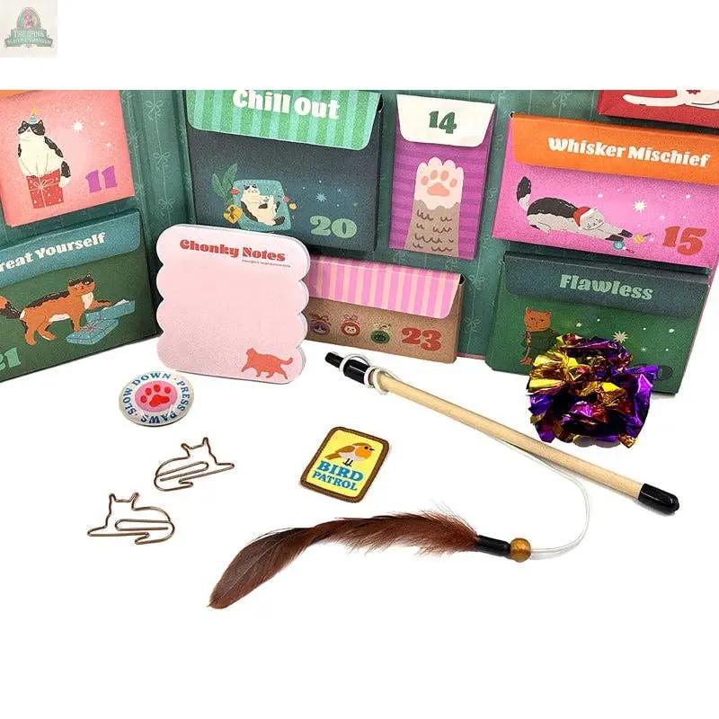 The Merry Catmas! Cat Lover's Advent features cat-themed gifts like a feather toy wand, crinkle ball, cat-shaped paper clips, and Chonky Notes—perfect for holiday gifting or anyone who loves unique cat collectibles.
