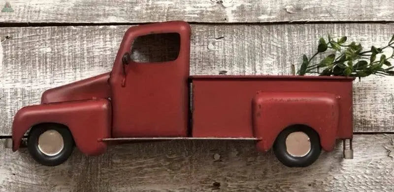 The Red Half Farm Truck is a vintage-inspired wall decor piece, featuring a red pickup with green foliage in the bed—perfect for adding rustic charm to any farmhouse-style space.