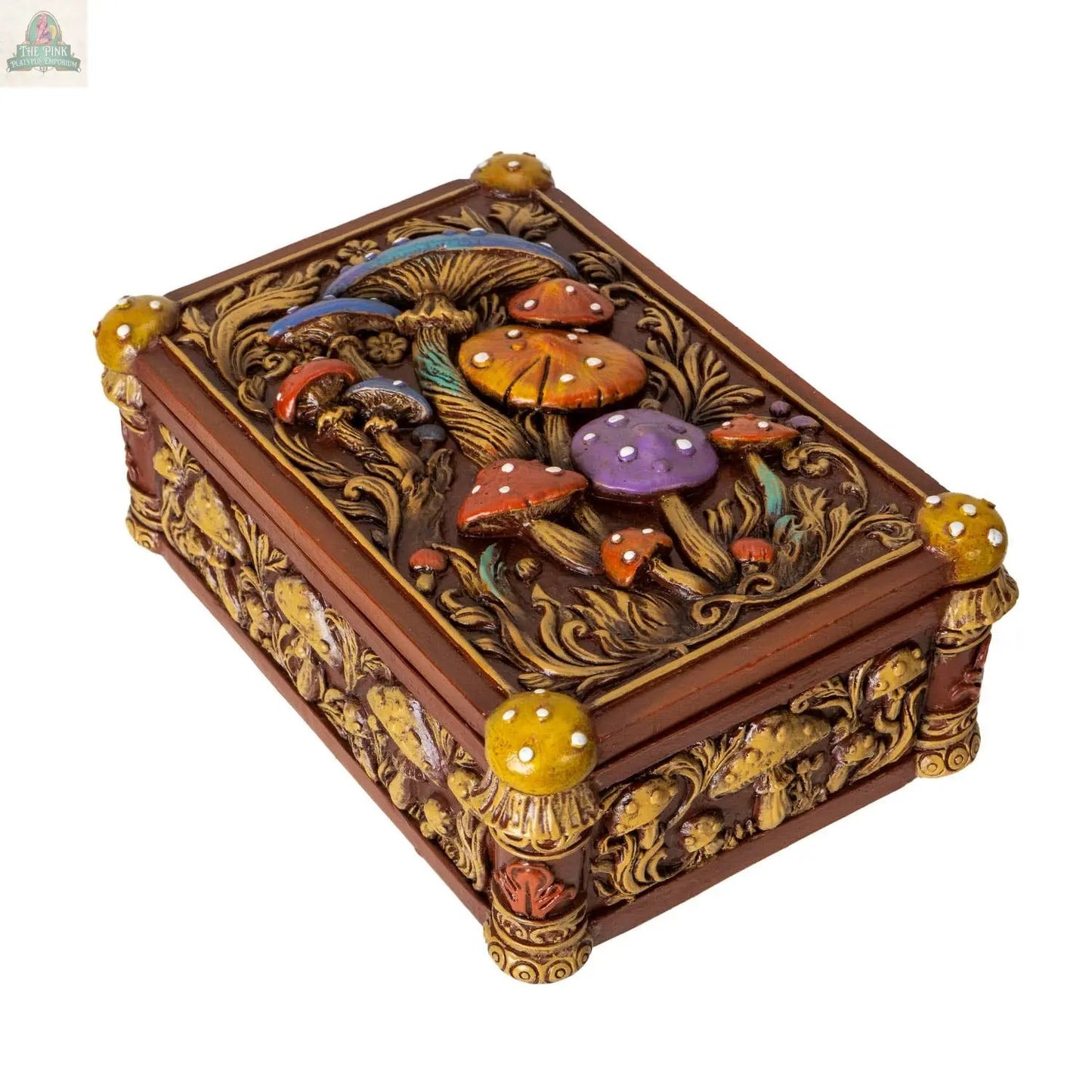 The Toadstool Mushroom Tarot Box is a decorative wooden storage box featuring ornate carvings, colorful mushroom reliefs on the lid, and yellow, mushroom-shaped knobs on the corners.