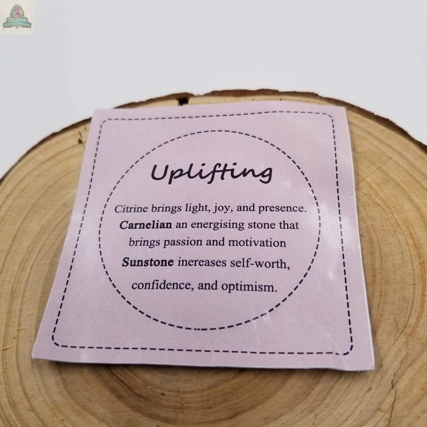 The Uplifting Mixed Crystal Healing Chakra Bracelet With Card by Pink Platypus Emporium features Citrine, Carnelian, and Sunstone, known for promoting joy, motivation, self-worth, confidence, and optimism. It comes with an informative square card.