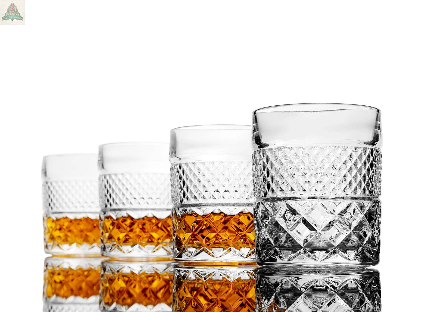 Four patterned glasses from the Whiskey Decanter With Glasses & Chilling Stones Gift Set are lined up on a reflective surface. Three contain different amounts of whiskey; the last is empty, all against a white background.