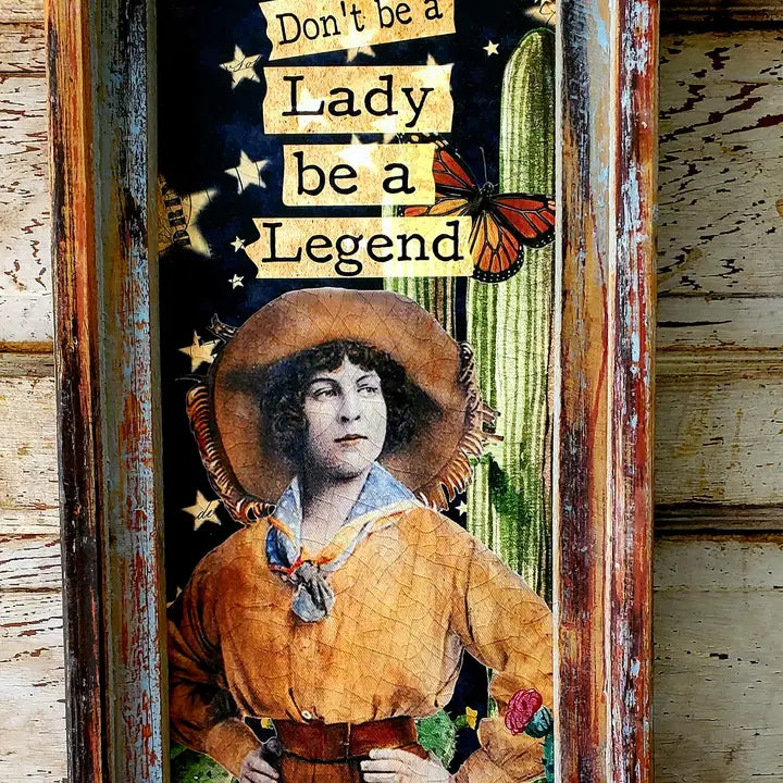 Vintage-style portrait with text 'Don't be a Lady, be a Legend' on a rustic wooden background.