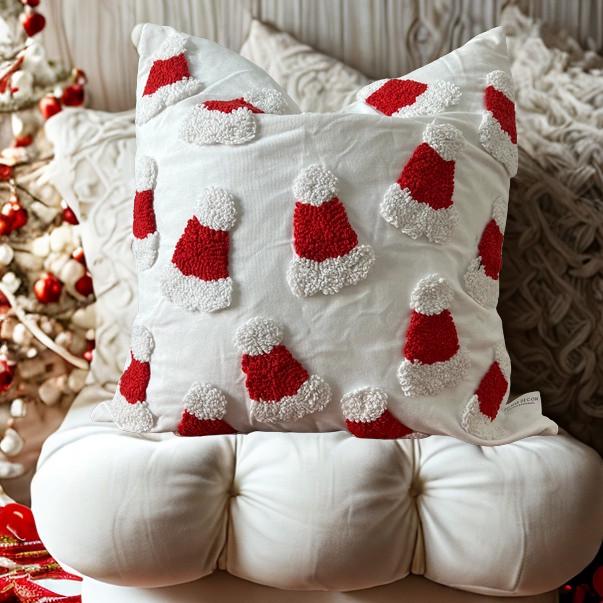 Decorative pillow with red and white santa hats on a textured surface