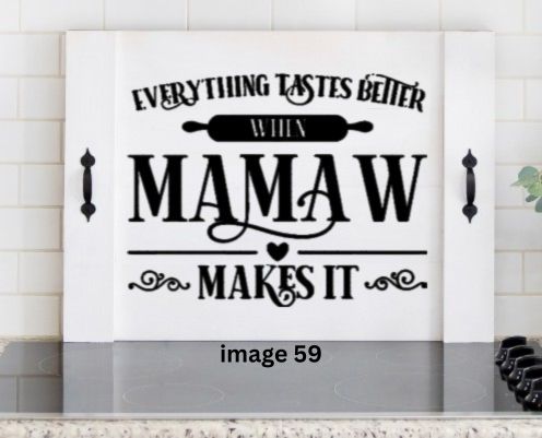 Pink Platypus Emporium Mamaw stove cover featuring Everything Tastes Better When Mamaw Makes It on a solid wood farmhouse noodle board.