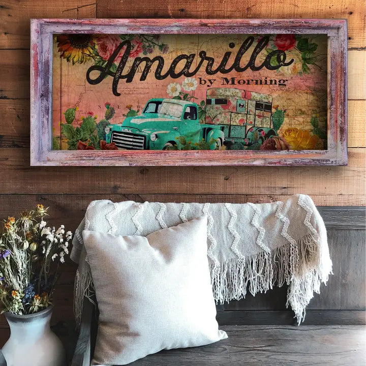 farmhouse wall decor with a truck and cacti design, titled 'Amarillo by Morning', above a couch with pillows and a blanket.