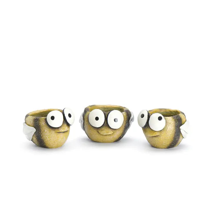 Three small ceramic bee-shaped plant pots with googly eyes on a white background