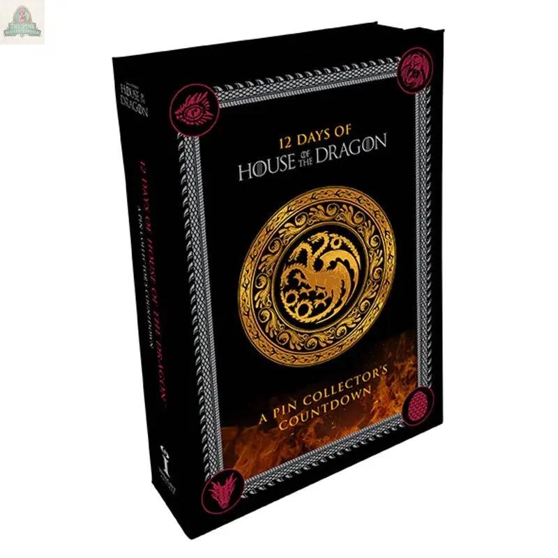 The 12 Days of House of the Dragon Advent Calendar features a black design with a gold Targaryen sigil, ornate borders, and House of the Dragon enamel pins—perfect for Game of Thrones fans and collectors.