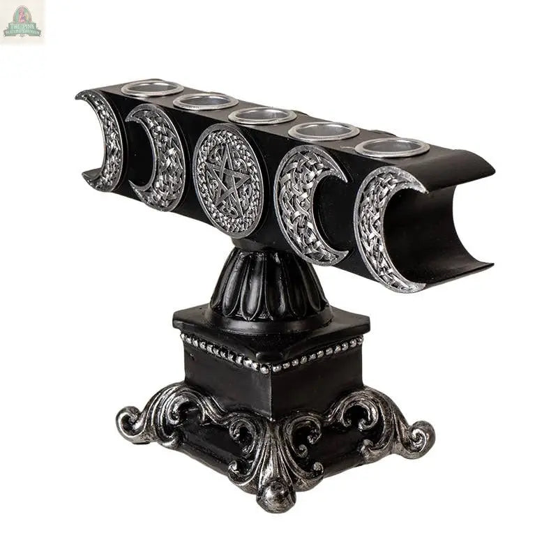 The Triple Moon Candleholder features black and silver cold cast resin, detailed crescent moons, a central pentagram, ornate base accents, and moon phases along the top.