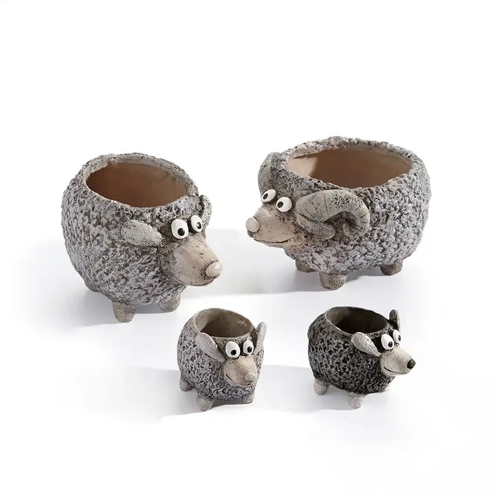 Set of four sheep-shaped planters on a white background