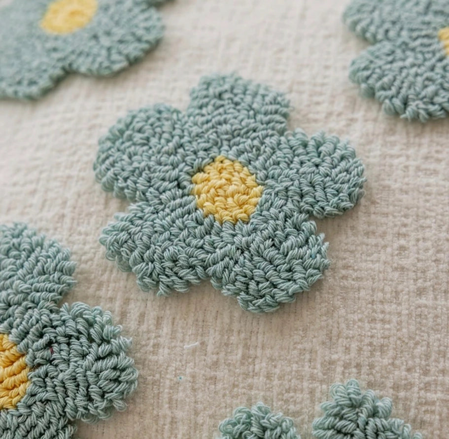 Crocheted flowers with yellow centers on a textured beige background