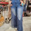 Person wearing a blue denim jeans with fringe on the sides in a clothing store
