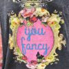 tshirt with floral design and "you fancy" text on a plain background
