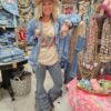 Person standing in a clothes store blue polka dot leggings with ruffles at the bottom 