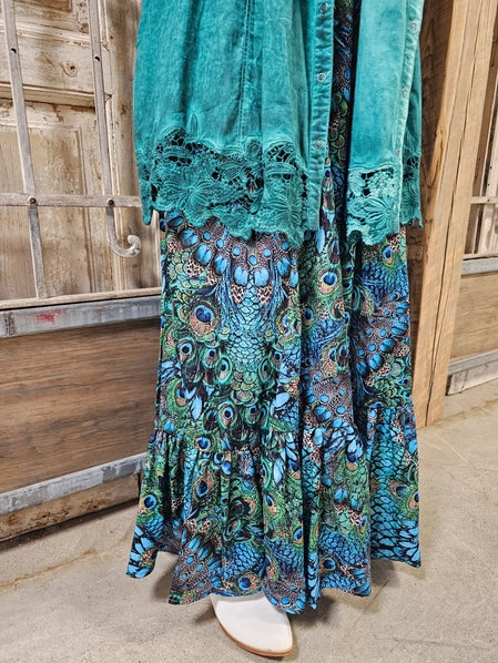 Teal jacket and pPeacock Feather Boho Pants against a wooden background