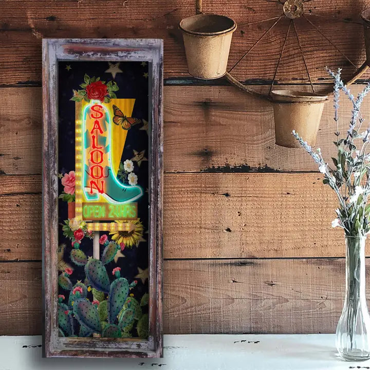 western wall art with boot and cactus design on a wooden wall.