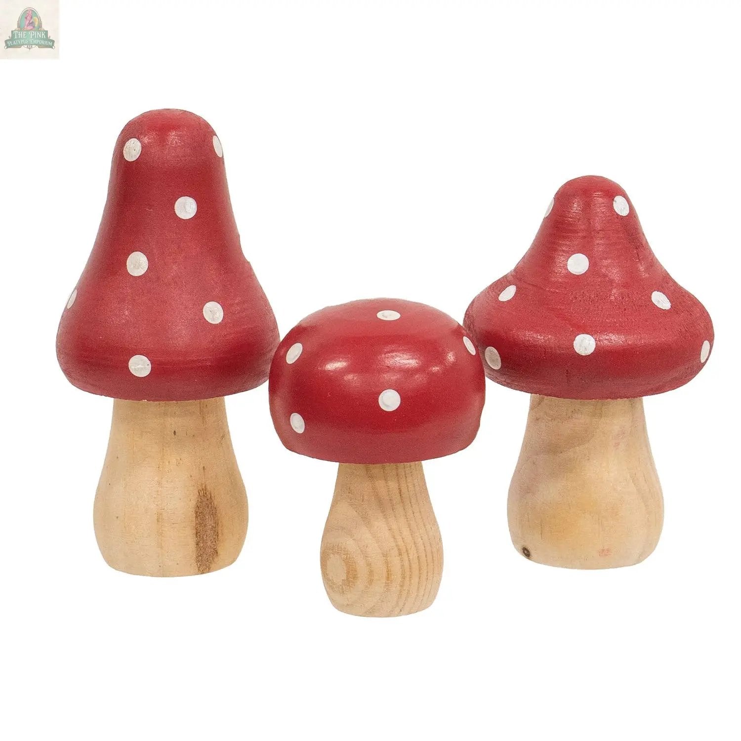 The 3/Set - Red & White Dotted Wooden Mushrooms feature natural-colored stems and red caps with white polka dots, making them a charming springtime display decor to brighten any space.