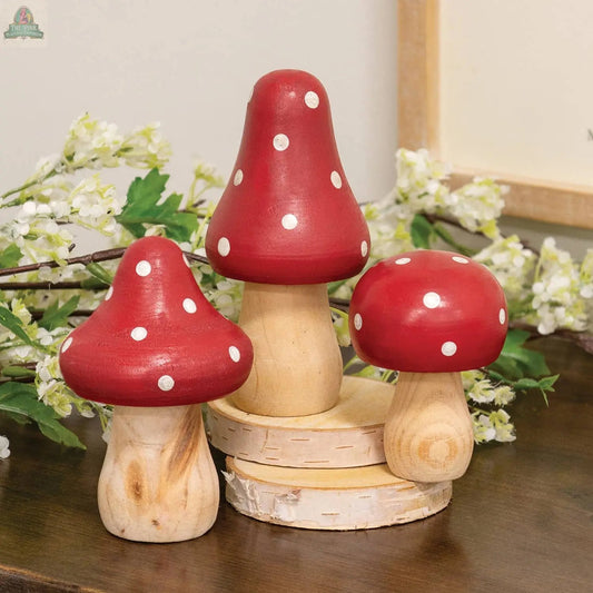 The 3/Set - Red & White Dotted Wooden Mushrooms features three decorative wooden mushrooms with red and white caps, perfect for charming spring decor and displays among flowers and greenery. Pink Platypus Emporium