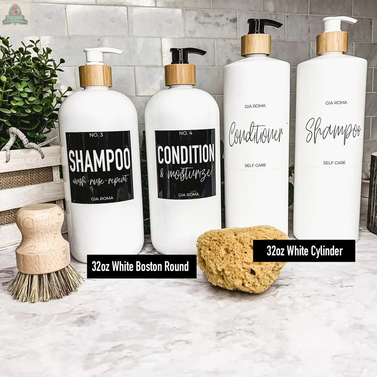 Four 32oz Plastic Cleaning Bottles with waterproof labels are neatly arranged on a counter with a natural sponge, scrub brush, greenery, and a woven basket, set against a tiled backsplash.