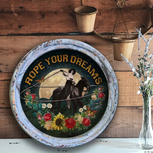 Decorative western wall art with a horse and rider illustration and 'Rope Your Dreams' text on a wooden background.