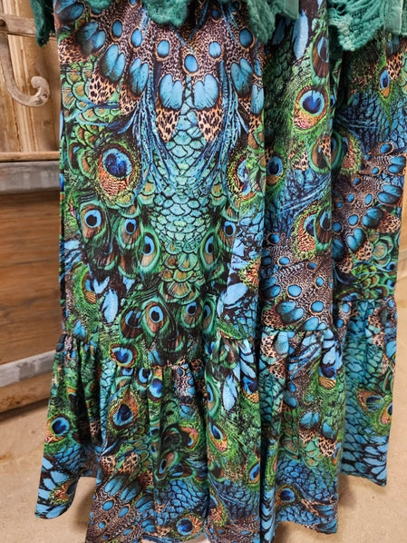Close-up of Peacock Feather Boho Pants on a wooden surface