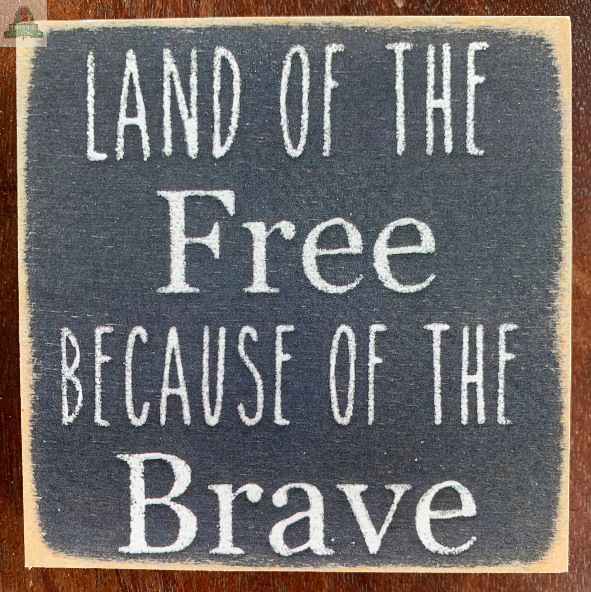 4X4-262 Land of The Free Wood Sign Pink Platypus Emporium