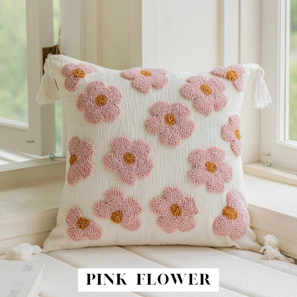 Decorative pillow with pink flower pattern on a light background