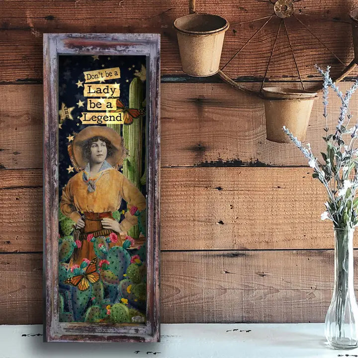 Vintage-style poster with a woman in a yellow dress and hat, surrounded by cacti and butterflies, on a wooden wall.