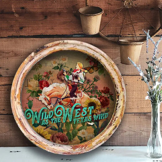 Decorative farmhouse wall decor with a cowboy and floral design, text 'Wild West as the Texas Wind', on a wooden wall.