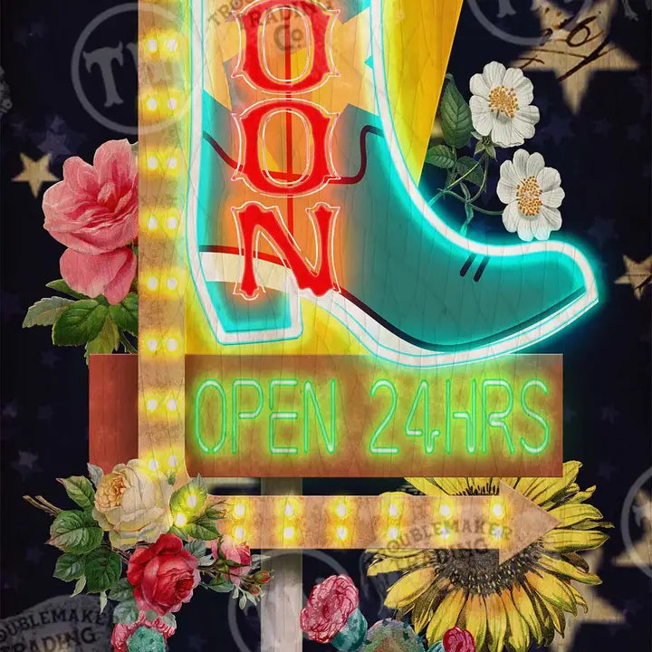 western wall art of a cowboy boot with 'SALOON' and 'OPEN 24HRS' text, surrounded by flowers and plants.