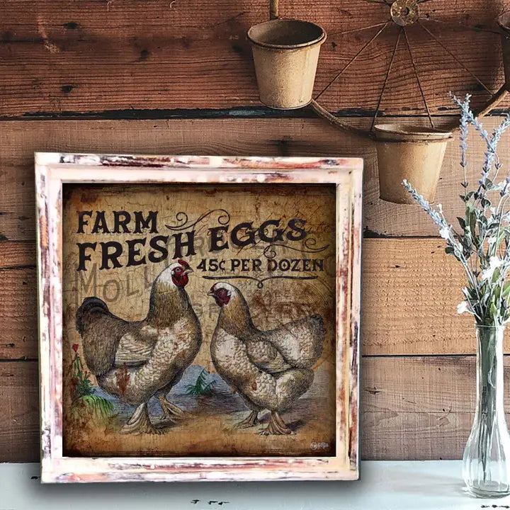 Decorative sign with 'Farm Fresh Eggs' text and chicken illustration on a wooden wall.