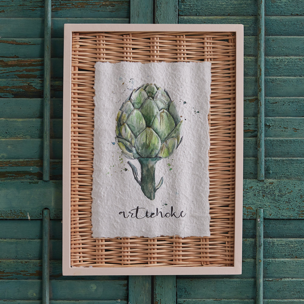 Framed towel with artichoke design on a textured green wall