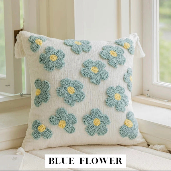 Decorative pillow with blue flower patterns on a light background