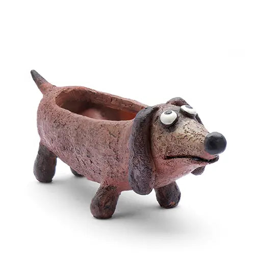 Ceramic dog-shaped planter on a white background