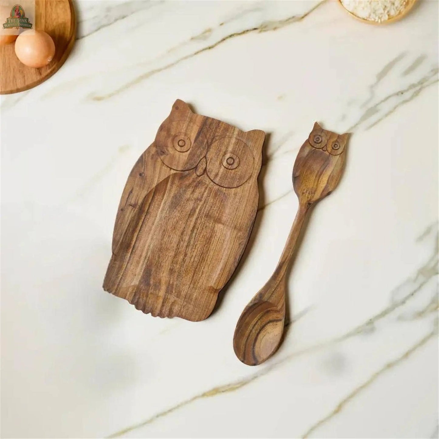 The Young's Acacia Wood Owl Spoon Rest With Spoon adds a charming, rustic touch to your marble countertop.