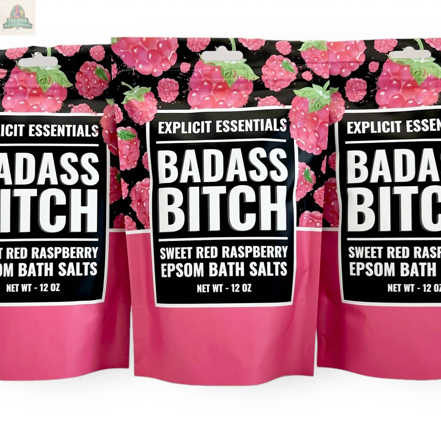 Three 12oz bags of Explicit Essentials' Bad Ass Bitch Bath Salts are shown with bold raspberry-themed packaging—an ideal, fun self-care gift for anyone who loves to unwind.