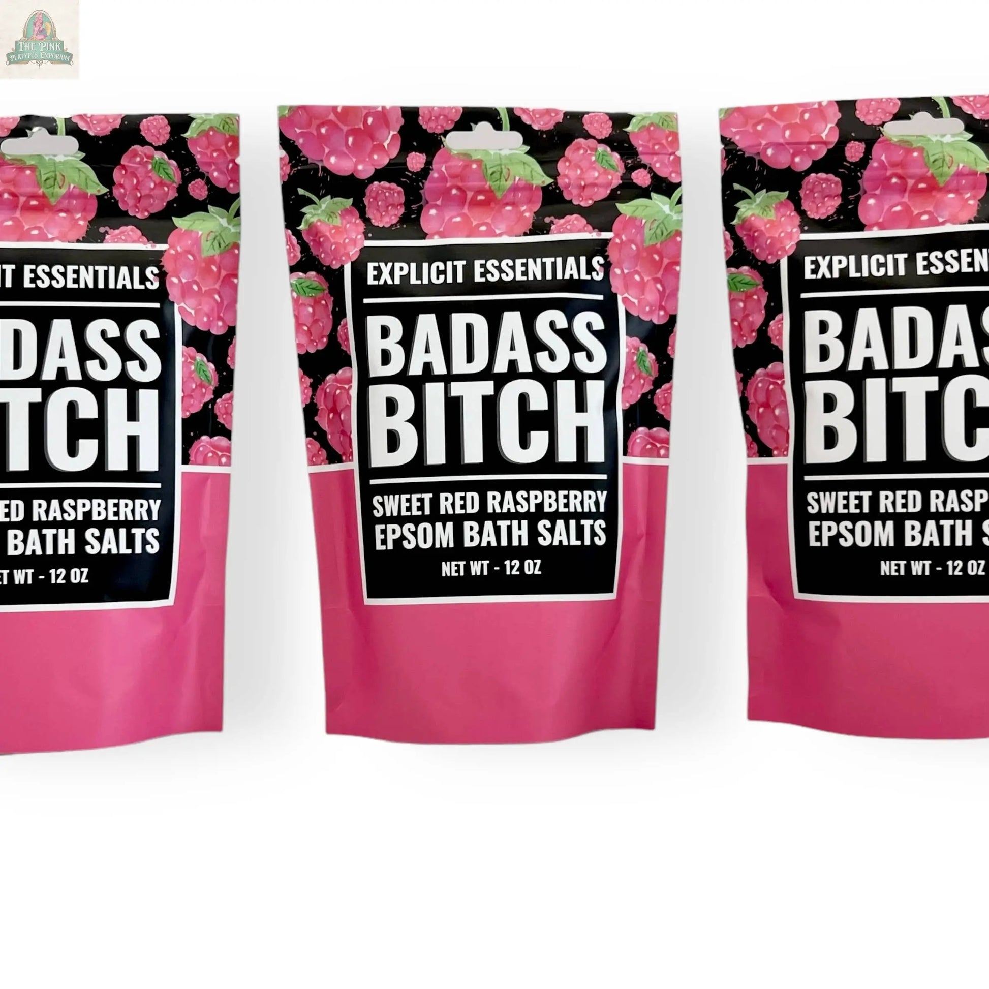 Three pink and black 12oz Bad Ass Bitch Bath Salts bags by Explicit Essentials, labeled Sweet Red Raspberry Epsom Salts with raspberry images and bold white text—perfect for self-care or as a thoughtful gift.