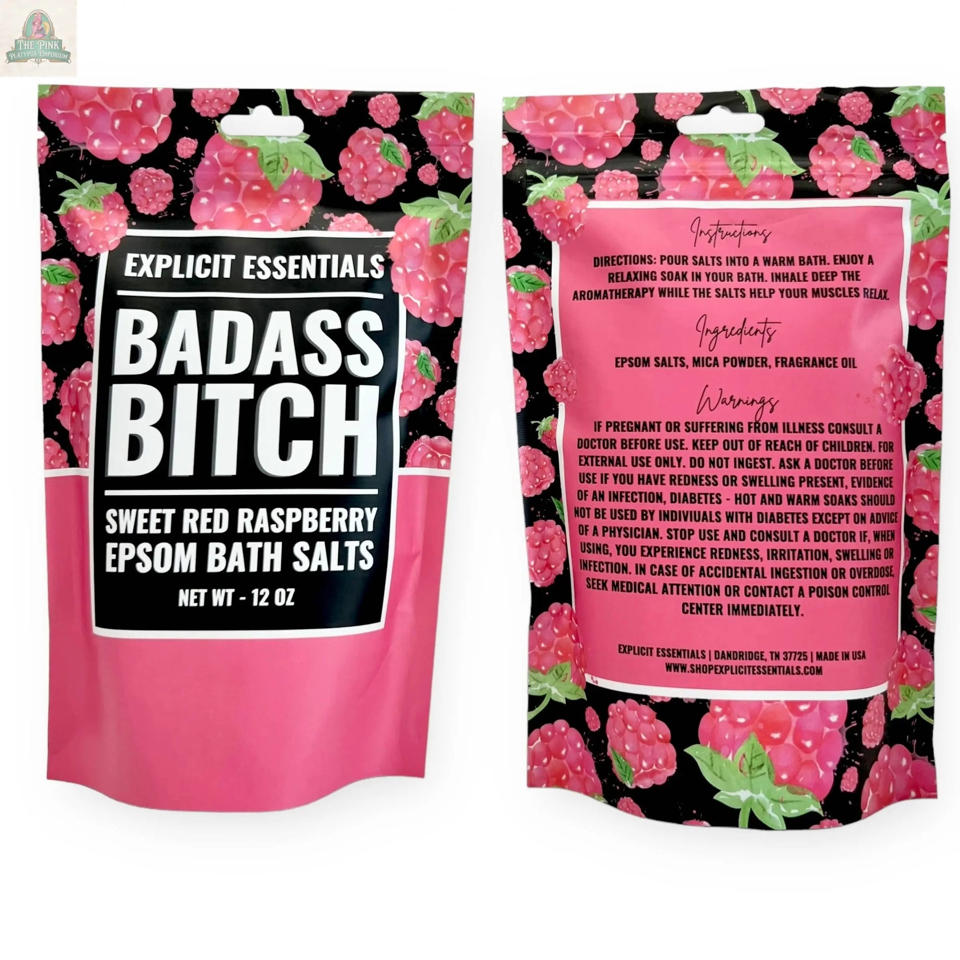 Two pink 12oz bags of Bad Ass Bitch Bath Salts by Explicit Essentials, featuring raspberry designs. These Epsom salts are a fun self-care gift. The front shows the name; directions and ingredients are detailed on the back.