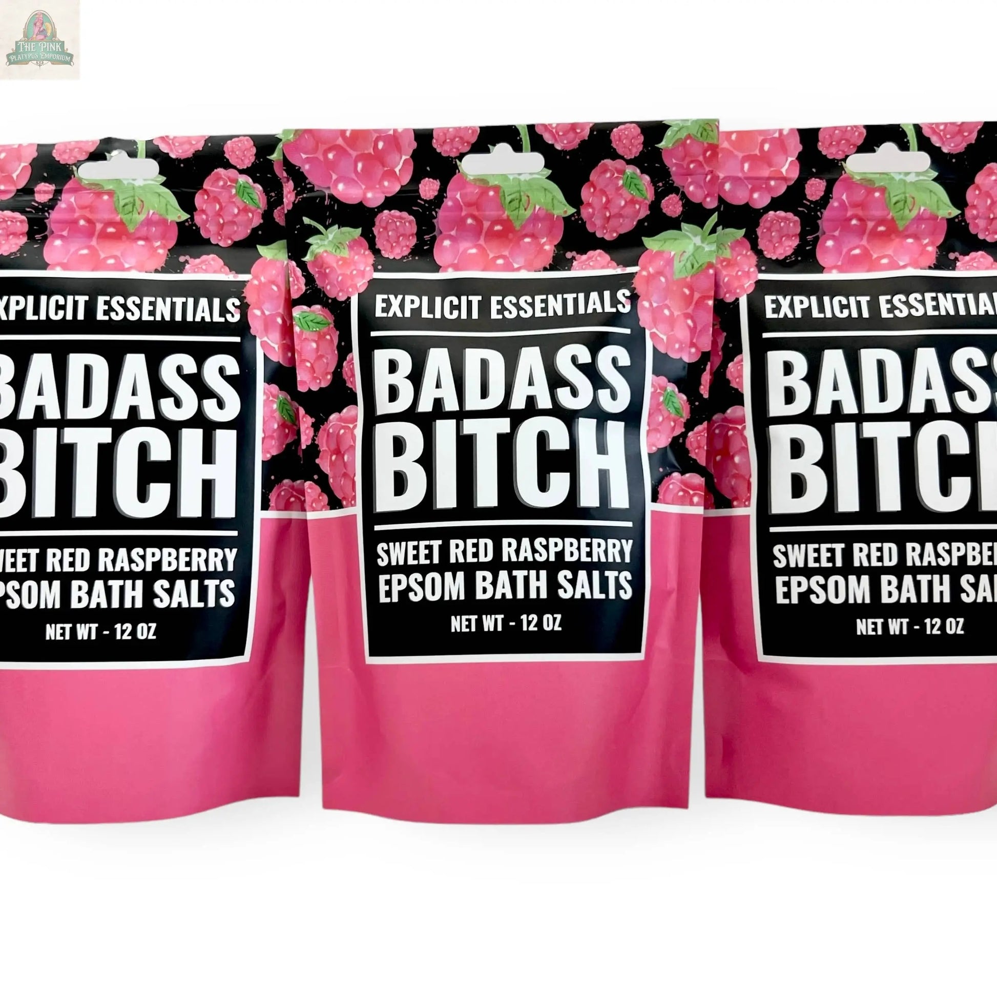 Three pink and black Bad Ass Bitch Bath Salts 12oz bags by Explicit Essentials, featuring raspberries and bold text. Perfect self-care gift for anyone embracing their inner badass.