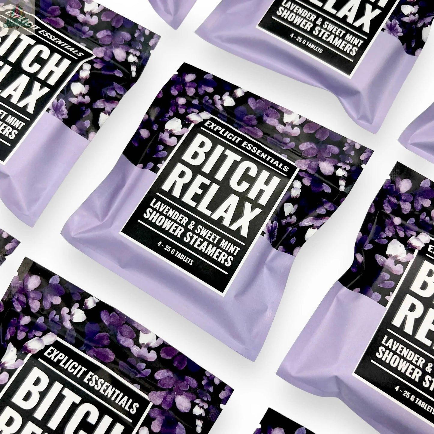Several Explicit Essentials Bitch Relax Shower Steamers are arranged diagonally on a white background. Featuring a Lavender & Sweet Mint scent, they make the perfect self-care gift.